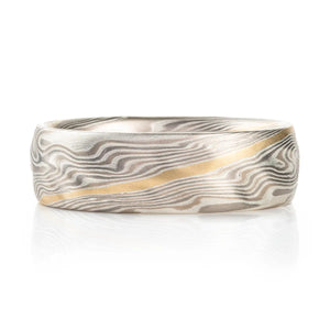 Mokume gane band with yellow gold contrast stripe and added carving for surface texture