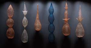 fiber art of woven wire into forms that resemble plants or sea forms. Botanical fiber shapes